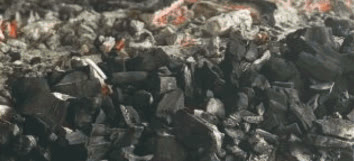 Glowing charcoal embers used for roasting lechon