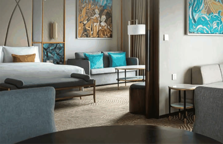 Fili Hotel suite at NUSTAR Resort with bedroom, sofa and Filipino artworks