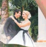 Wedding couple embracing in the resort garden